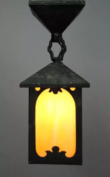 A lamp hanging from the ceiling of a room.