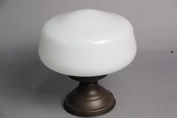 A white lamp sitting on top of a metal stand.