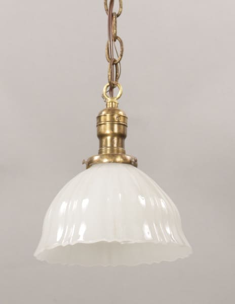 A 10431. 1930's Milk Glass Pendant with a brass fixture and a white fluted glass shade, hanging from a chain against a gray background.