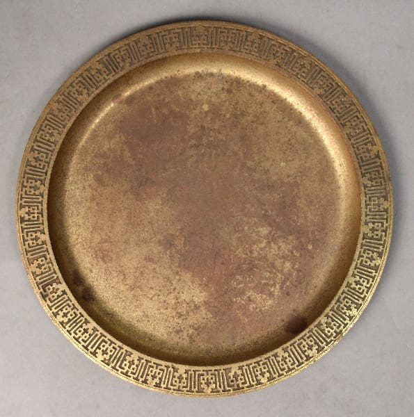 An old, circular 10464. Early 20th Century Tiffany Studios New York Gilt Bronze Tray with an ornate, patterned rim, displayed on a gray background.