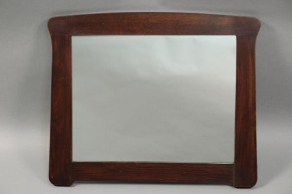 A rectangular wooden Arts And Crafts Oak Mirror with a dark stained frame, displayed against a neutral gray backdrop.