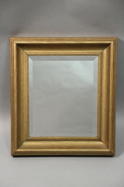 A simple gold 10621. Circa 1920's Mirror With Nice Beveled Frame displayed within, against a light gray backdrop.
