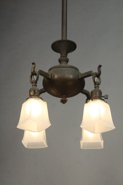 11495. Arts & Crafts Mission Circa 1910 Chandelier with two lit frosted glass lamps suspended from a metal fixture.