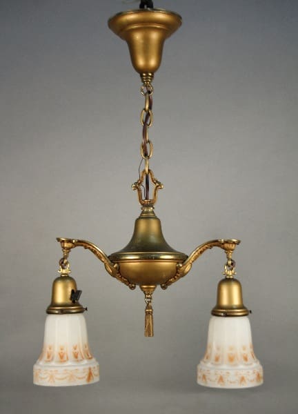 Sentence using product name: 11827. Antique Brass Turn Of The Century Chandelier With Original Art Glass Shades with three arms, each holding a bell-shaped, frosted glass shade decorated with floral patterns.