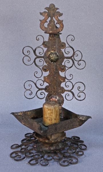 11877. Attractive 19th Century Spanish Candle Holder with intricate scrollwork and a central spike, featuring a weathered finish on a plain background.