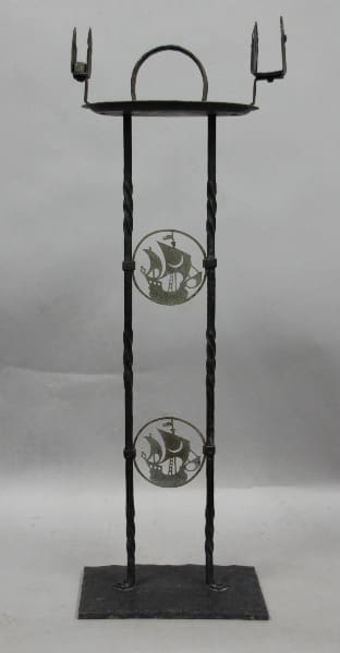 A 12013. 1920's Spanish Revival smoke stand with a Galleon motif, featuring two decorative circular plates with fish motifs, supported by a sturdy square base.