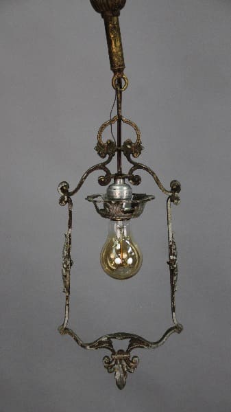 An antique hanging oil lamp with ornate metal frame and a glass bulb, suspended from a decorative chain. (Product Name: 12700. Single Downlight Pendant Circa 1920's)