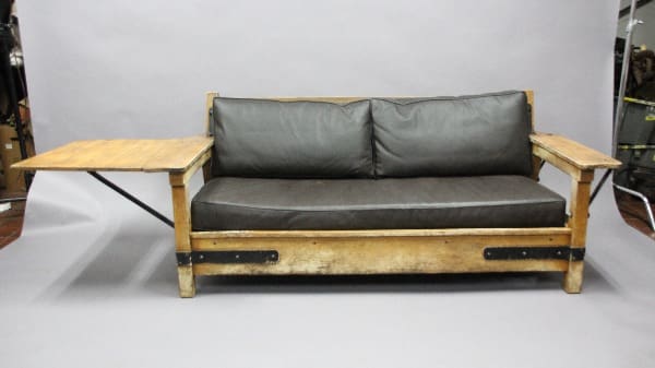 A 12758. Rare Signed Monterey Sofa with Side Panel with a gray cushion and integrated wooden side tables, set against a plain backdrop.