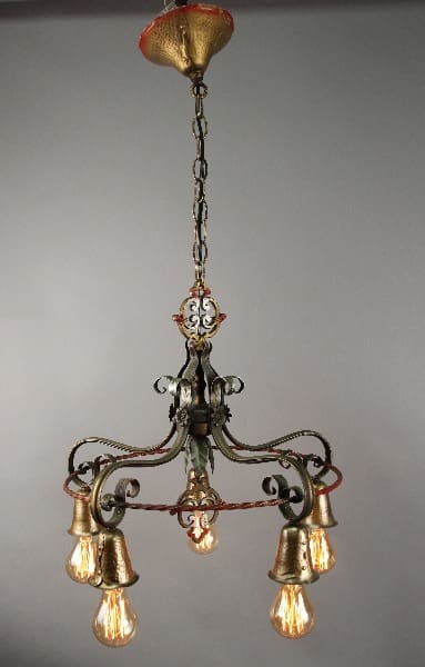 13656. 1920's Spanish Revival Chandelier With Down Lights with four illuminated bulbs, ornamental metal frame, and a chain hanging from a ceiling fixture.