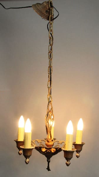 13662. Small 1920's Chandelier With Original Finish with five electric candles, suspended by a chain, illuminated against a plain background.