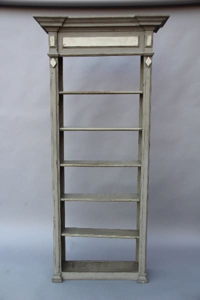 An antique 13733. Pair of Turn Of The Century Hall Bookcase with five shelves and a decorative top, set against a simple blue background.