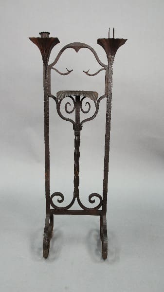 Antique Spanish Revival 1920's wrought iron music stand with decorative elements, including floral motifs at the top and scrolled feet.