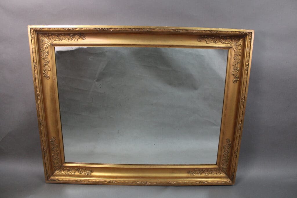 An ornate 14172. 1920's Very Large Scale Mirror with detailed floral patterns, shown against a gray background.