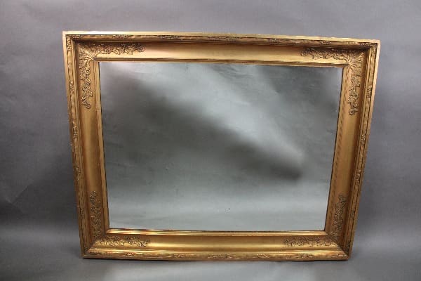 A 14184. Large Scale Turn Of The Century Elegant Gilt Framed Mirror surrounding a blank, reflective gray area against a muted gray background.