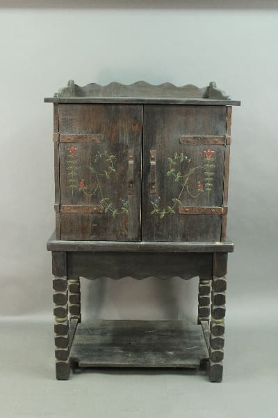 Antique 14392. Custom Monterey Style Bar Cabinet with floral designs on doors, featuring a scalloped top edge and supported by a sturdy base with a lower shelf.