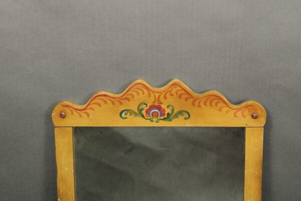 Traditional wooden chair with a decorative, scalloped top rail painted with floral and swirl patterns against a gray background. 14429. Lovely Spanish Revival Hand Painted Mirror
