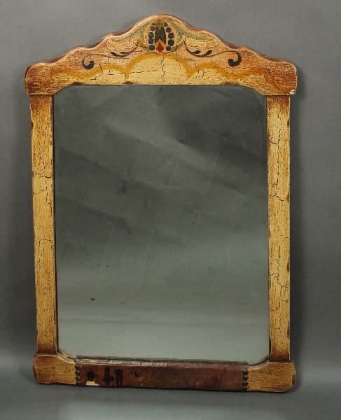 14431. Hand Painted Mirror With Leather Detailing with a decorative, rustic wooden frame featuring floral patterns at the top.