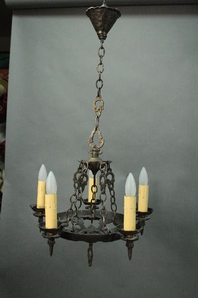 14608. 1920's Five Light Chandelier With Hammered Finish with five electric candles, suspended by a chain against a gray background.