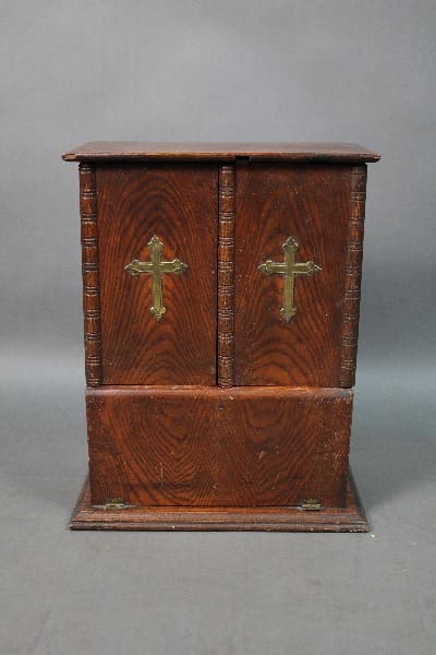 14619. Early 19th Century Alter Box with double doors, each featuring a brass cross, standing on a base against a gray backdrop.