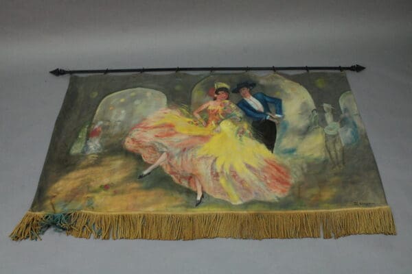 A vintage tapestry depicting a vibrant ballroom scene with a dancing couple, the woman in a flowing yellow dress, and a man in blue, against a dimly lit background with onlookers, like the 14879. Spanish Revival Hand Painted Mural And Rod.
