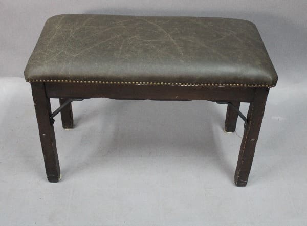 A vintage 15047. Monterey Style Piano Bench with iron bracket and new leather upholstery.