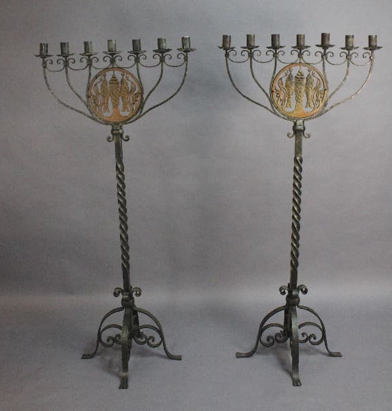 Two tall, 15055. Outstanding Pair Of 1920's Iron And Bronze Candelabra in The Manner Of Oscar Bach with twisted stems and decorative coin emblems at the center, each holding multiple candle slots.