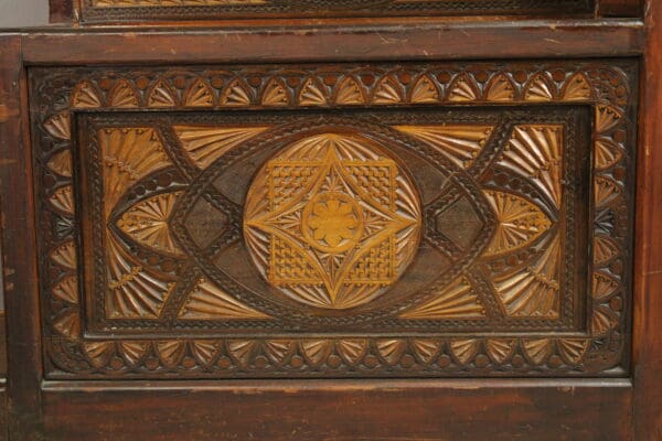 Intricately carved wooden panel featuring geometric patterns and a central floral design, set within a carved border. 15109. Turn Of The Century Moorish Coat Rack