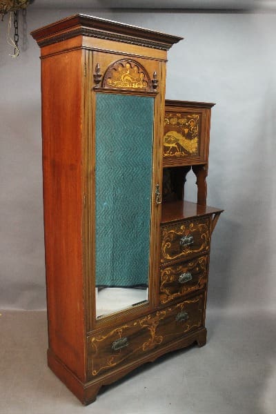 Antique 15110. HOLD b.a. ~ Circa 1900 Art Nouveau Carved and Inlaid Armoire And Drawer with ornate carvings and a blue textured door panel, displayed against a gray background.