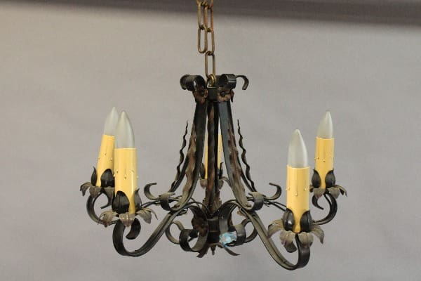 A 15215. Spanish Revival 1920's Chandelier With Acanthus Leafs with ornate metal design and five candle-like bulbs.