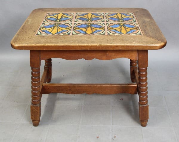 15324. Spanish Revival American Encaustic Tiled Table with a decorative blue and yellow tile inlay on the top surface, supported by four chunky, turned legs.