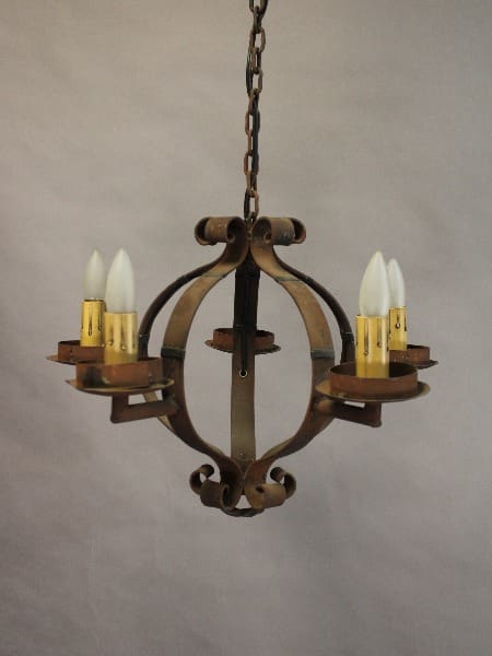 Antique bronze 15353. 1 of 2 simple Wrought Iron Spanish Revival Chandelier with four candle-shaped bulbs, suspended by a chain against a neutral gray background.