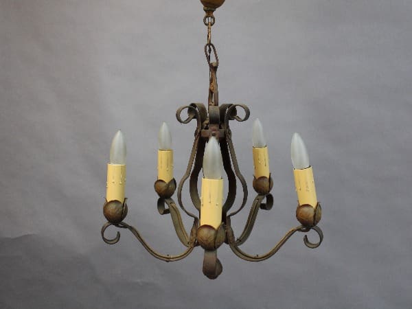 An antique 15381. 1920's Chandelier With Simple Lines with five candle-like bulbs against a gray background.