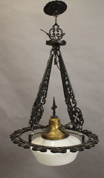 Antique 15397. 1920's iron and brass chandelier with milk glass shade, suspended by chains from a ceiling fixture.