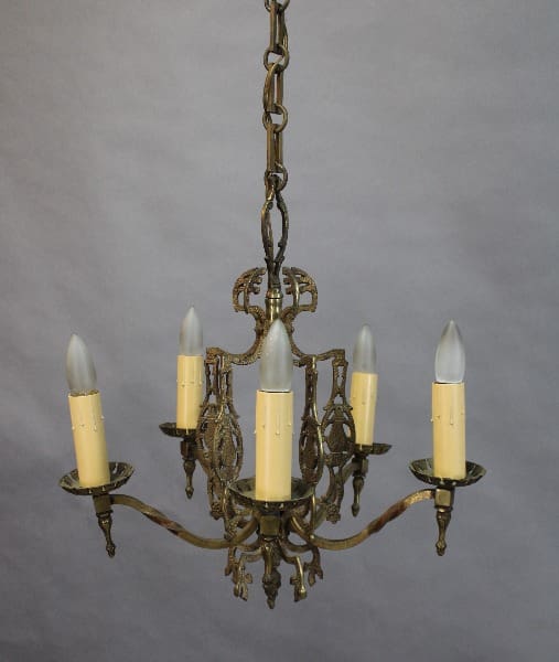 15400. Cast Bronze 1920's Chandelier With Original Finish with five candle-like lights against a gray background.