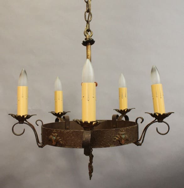 A circular 15403. Spanish Revival 5 Lights Chandelier with six candle-shaped light bulbs, decorative elements, and a central chain for hanging.