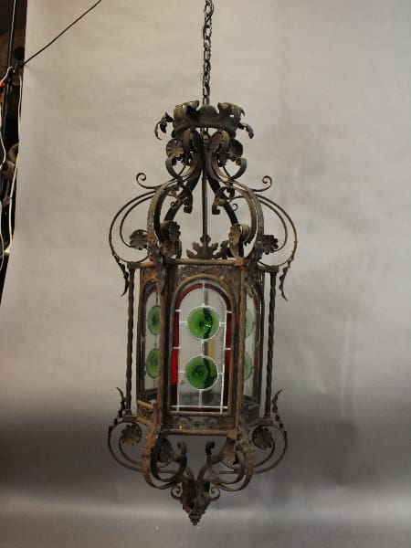 Vintage 15431. Large Scale 1920's Pendant With Rondelle Panels with ornate metalwork and green glass panels hanging from a chain.