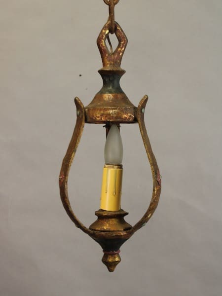 An 15487. Circa 1920's pendant with original finish with a single white bulb enclosed in an oval frame, exhibiting signs of tarnish and wear.