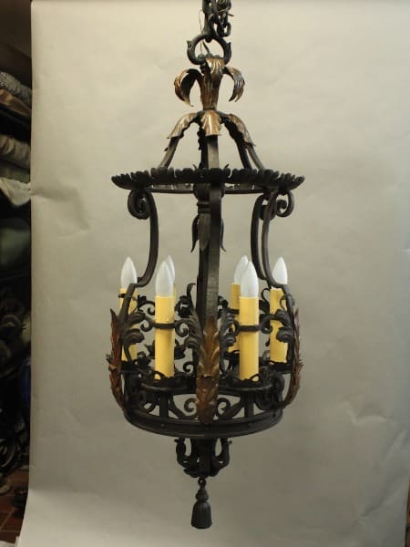 Vintage 15784. Rare Large Scale 1920's Wrought Iron and Bronze Pendant with ornate metalwork, featuring candle-like bulbs, suspended against a white backdrop.