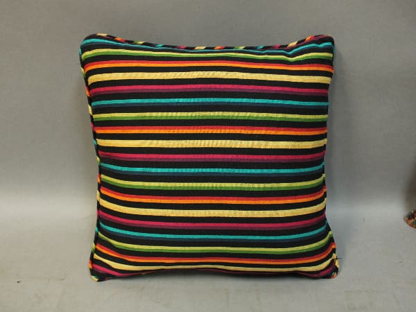 A 15837. 1 of 4 Decorative Pillow with a pattern of narrow horizontal stripes in multiple colors, including blue, green, yellow, orange, and red.