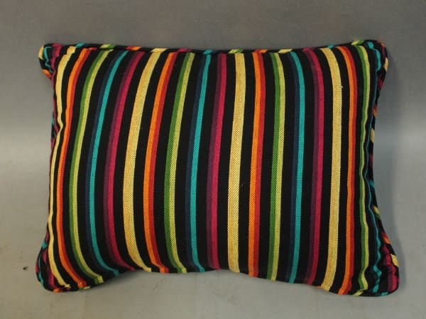 A colorful striped throw pillow with horizontal bands of red, yellow, green, blue, and black on a grey background. 15844. 1 of 4 Monterey Style Pillows