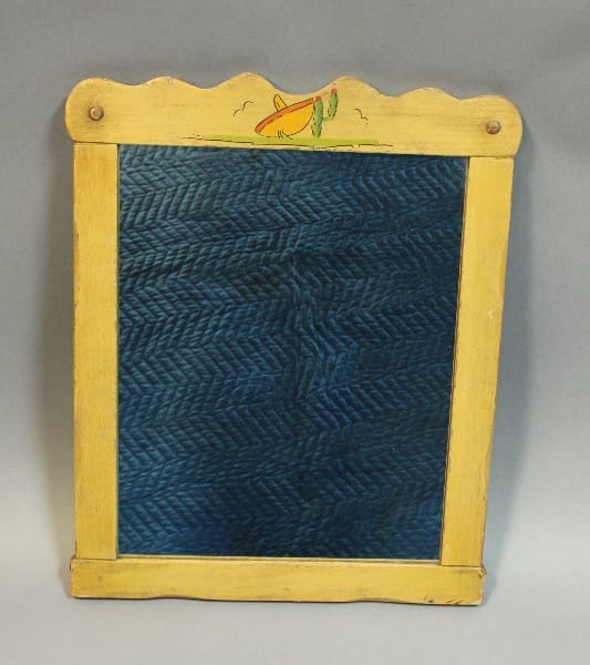 Vintage wooden washboard with a blue rippled metal scrubbing surface and a yellow frame decorated with a Rancho mirror with hand painted sombrero and cactus.