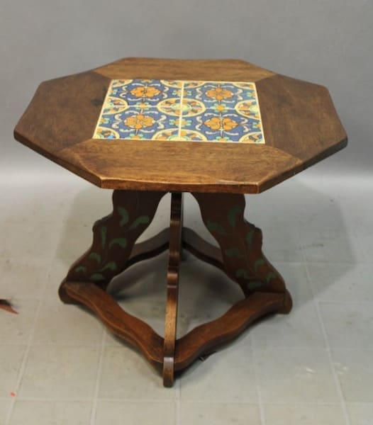 Octagonal 15858. Spanish Revival 1920's Tile Table with a colorful tile inlay on the top and a green floral pattern on the base, positioned on a plain background.