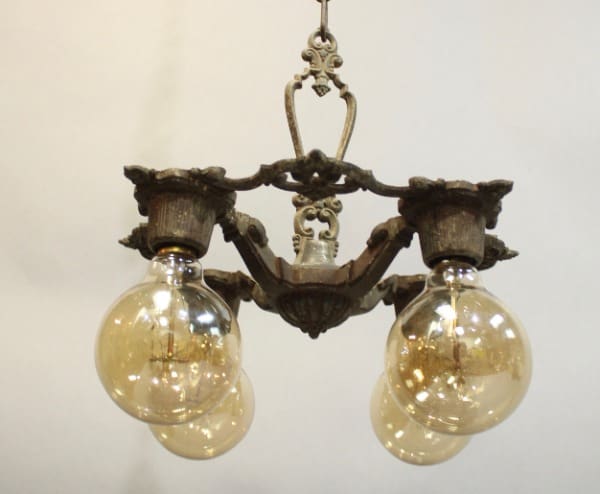 Sentence with Product Name: 15934. 1920's Chandelier With Down Lights with two illuminated globe bulbs and ornate metal frame, suspended against a plain white background.