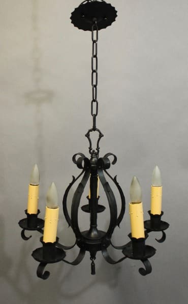 15935. 1920's Iron Chandelier With Simple Lines with six candle-shaped light bulbs, suspended by a chain, displayed against a gray background.