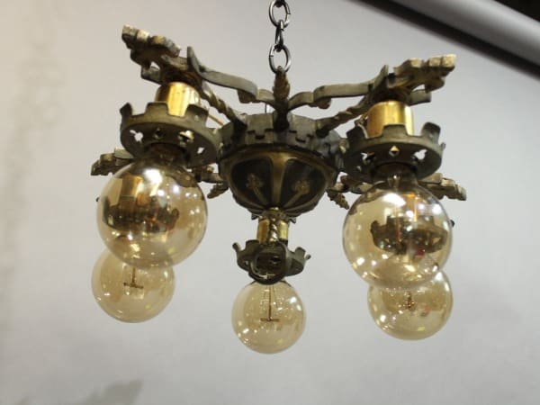 15938. 1920's Ceiling Mount With Five Lights with four glowing light bulbs, hanging by a chain, against a white background.