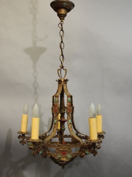 15954. Classic Spanish Revival Chandelier With Original Finish with ornate metalwork and painted details, featuring four candle-shaped bulbs, hanging from a chain.