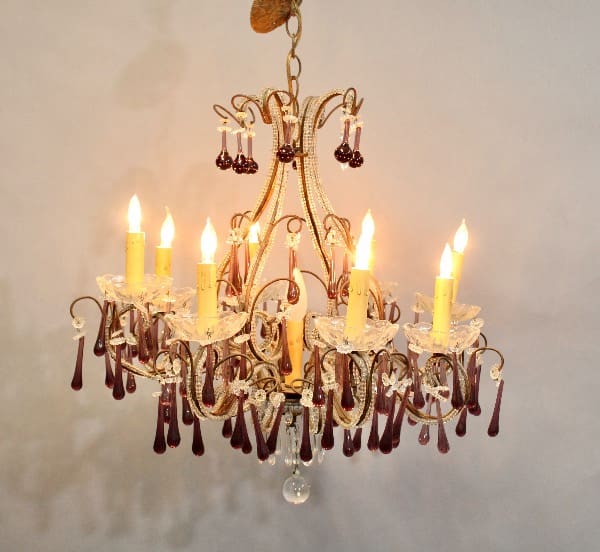 15982. European Crystal Chandelier With Lilac Crystals with lit candles and dangling crystal decorations against a neutral background.