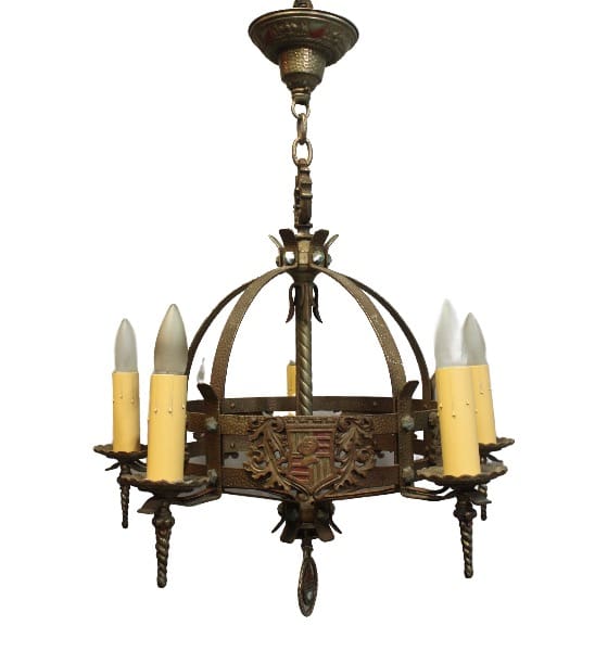 15994. Five Light 1920's Spanish Revival Tudor Chandelier With Crest Motif with a medieval design featuring a circular metal frame, ornate details, and six candle-like bulbs.