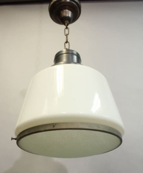 A 16026. 1930's Glass Pendant With Pebble Glass Diffuser with a translucent glass shade and metal fixtures, hanging from a ceiling.