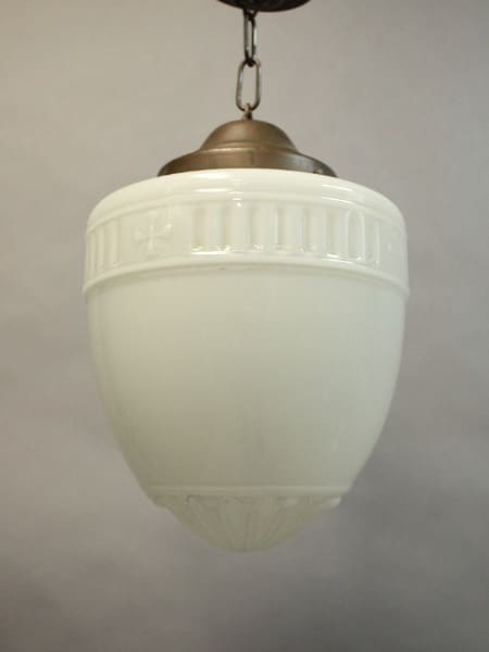 A 16045. 1920's Pendant With Original Glass Shade with decorative embossed details, hanging from a metallic fixture against a neutral backdrop.
